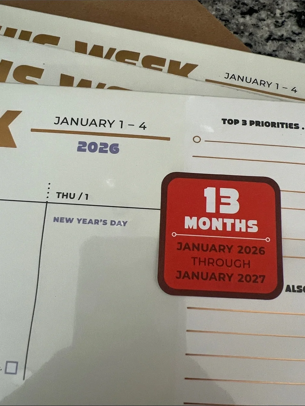 3 Knock Knock This Week Desk Planner Pad — Beige, Purple & Gold accents.